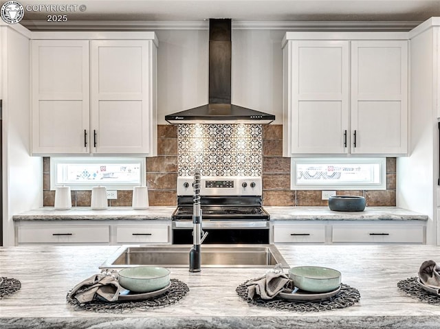 kitchen featuring white cabinetry, backsplash, stainless steel range with electric cooktop, and wall chimney exhaust hood