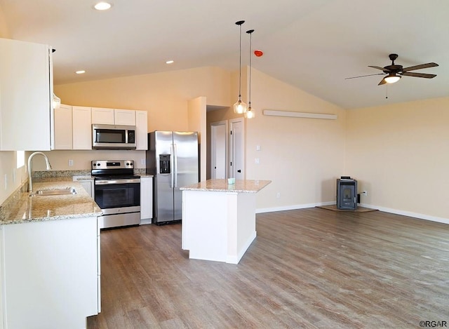 kitchen featuring pendant lighting, white cabinetry, sink, a center island, and stainless steel appliances