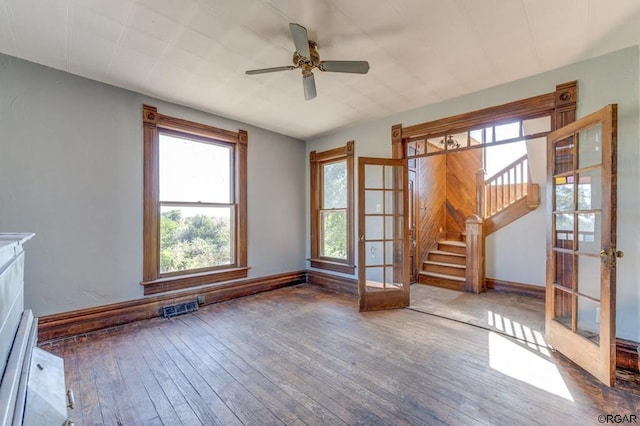 unfurnished living room with wood-type flooring, french doors, and ceiling fan