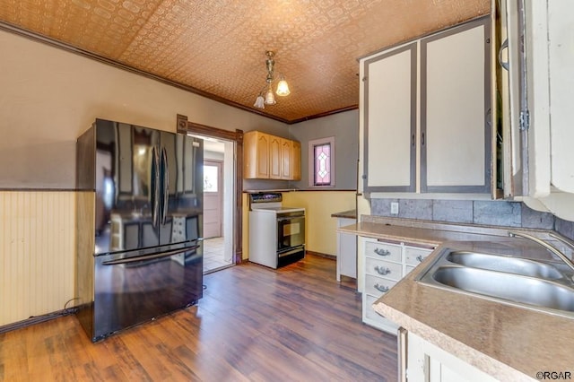 kitchen featuring electric range oven, dark hardwood / wood-style floors, sink, ornamental molding, and black fridge