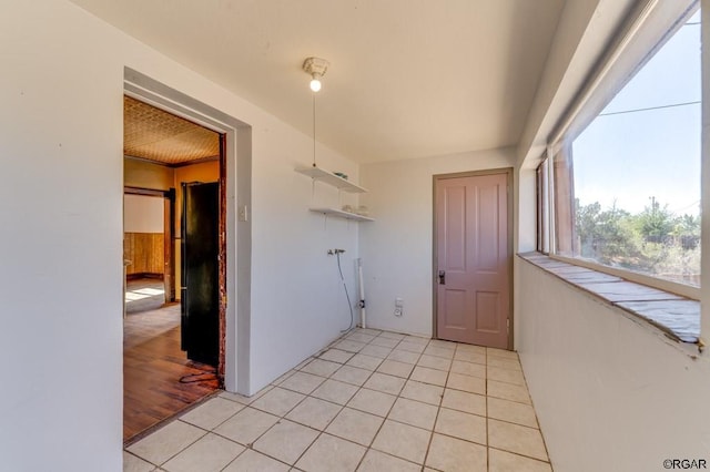 clothes washing area featuring light tile patterned floors