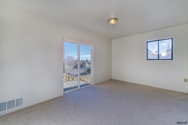 unfurnished room with plenty of natural light and carpet