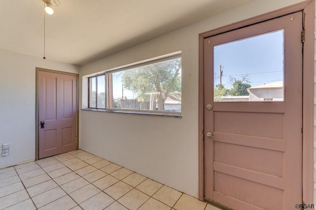 doorway with light tile patterned floors