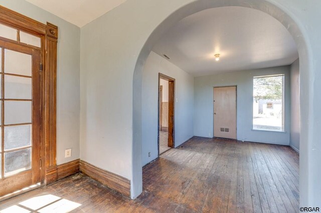 empty room with dark wood-type flooring