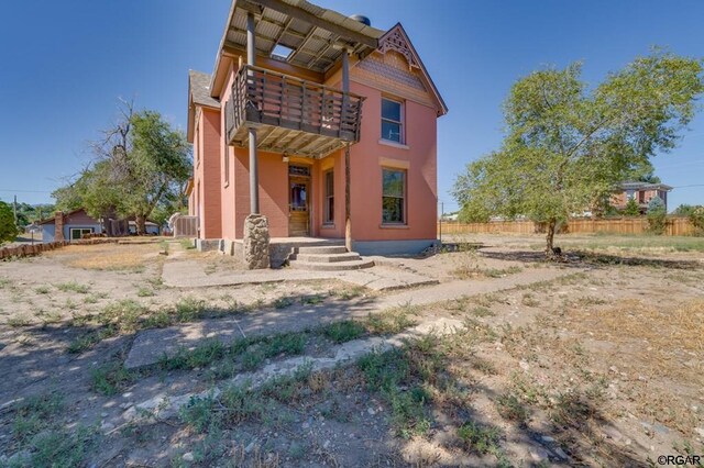 rear view of property featuring a balcony