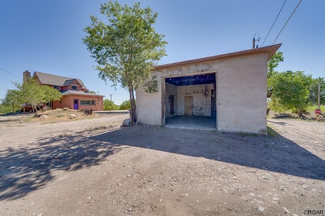 exterior space with an outbuilding and a garage