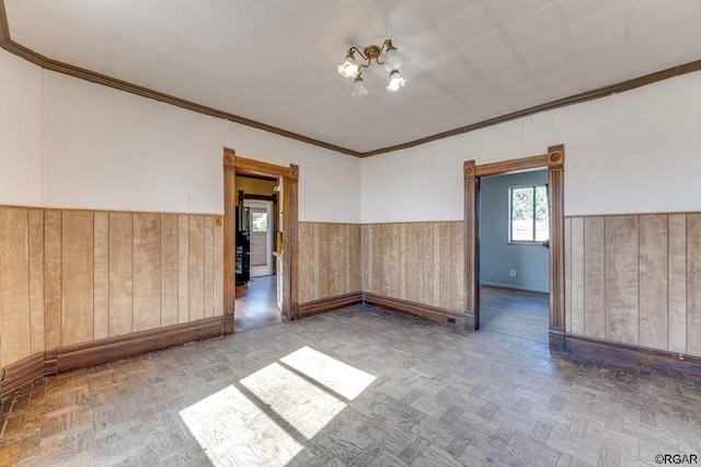 unfurnished room with parquet flooring and ornamental molding