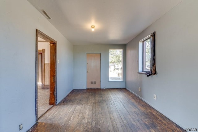 unfurnished room featuring dark hardwood / wood-style flooring