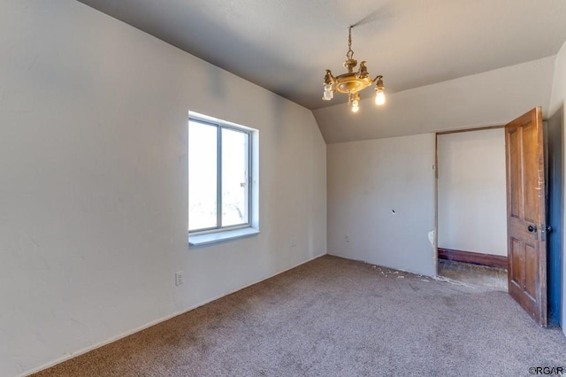 interior space with vaulted ceiling, light carpet, and a chandelier