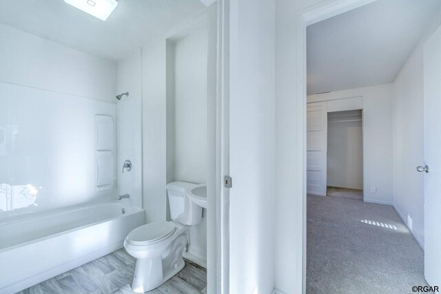 bathroom featuring bathtub / shower combination and toilet