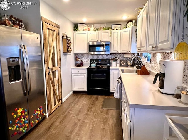 204 Indian Hills Rd, Florence, CO 81226 - kitchen featuring appliances with stainless steel finishes, wood finished floors, light countertops, tasteful backsplash, and recessed lighting