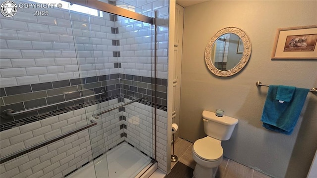 bathroom featuring an enclosed shower and toilet