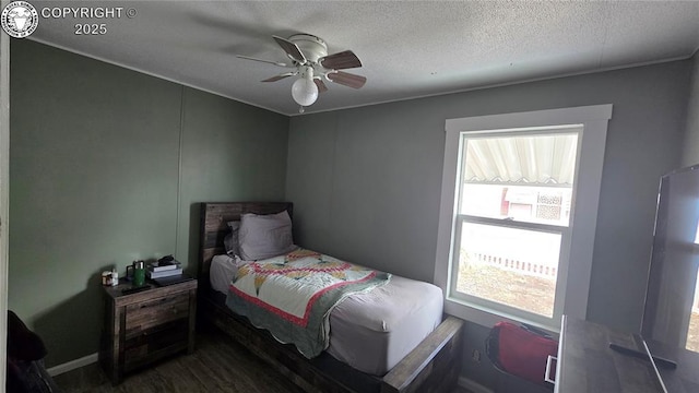 bedroom with ceiling fan and a textured ceiling