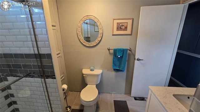 bathroom with vanity, toilet, and an enclosed shower