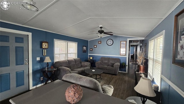 living room featuring vaulted ceiling, ornamental molding, dark hardwood / wood-style floors, and ceiling fan