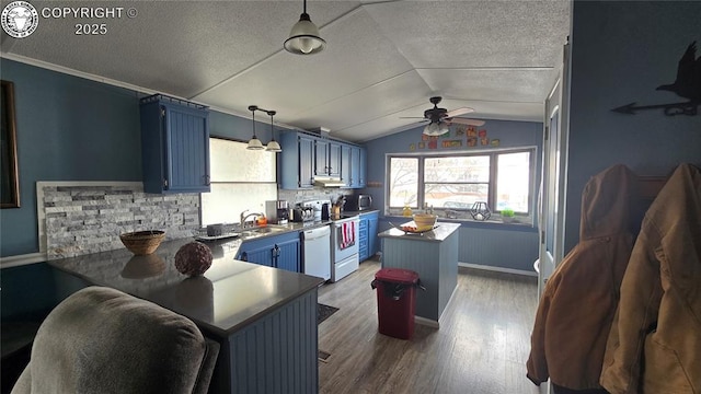 kitchen with dark hardwood / wood-style floors, pendant lighting, white dishwasher, kitchen peninsula, and blue cabinetry