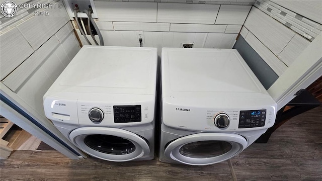 laundry room featuring dark wood-type flooring and washing machine and clothes dryer