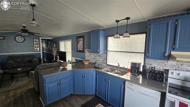 kitchen featuring white dishwasher, sink, kitchen peninsula, and blue cabinets