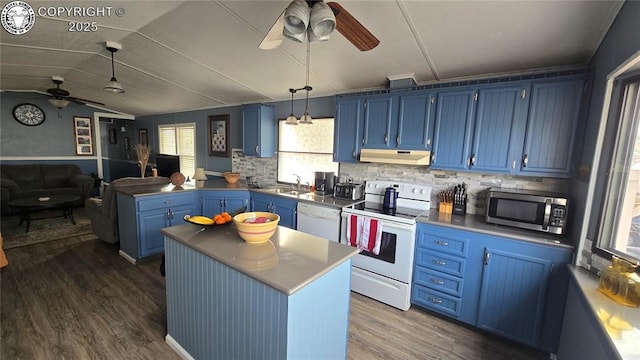 kitchen with blue cabinets, a kitchen island, white appliances, and decorative light fixtures