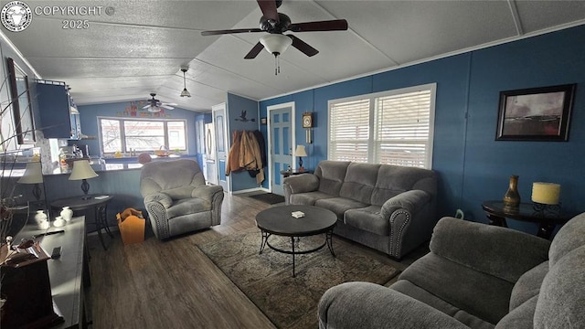 living room featuring ceiling fan, lofted ceiling, and dark hardwood / wood-style floors