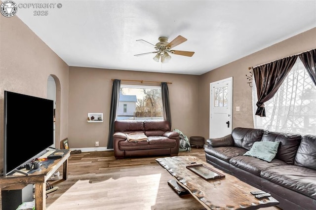 living room with ceiling fan and light hardwood / wood-style floors