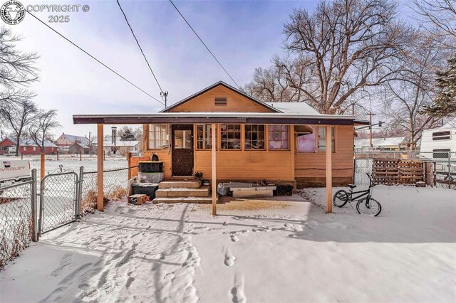 view of snow covered rear of property