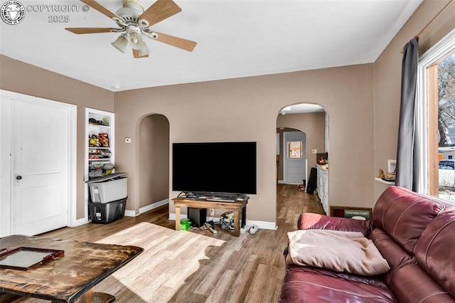 living room featuring hardwood / wood-style flooring and ceiling fan