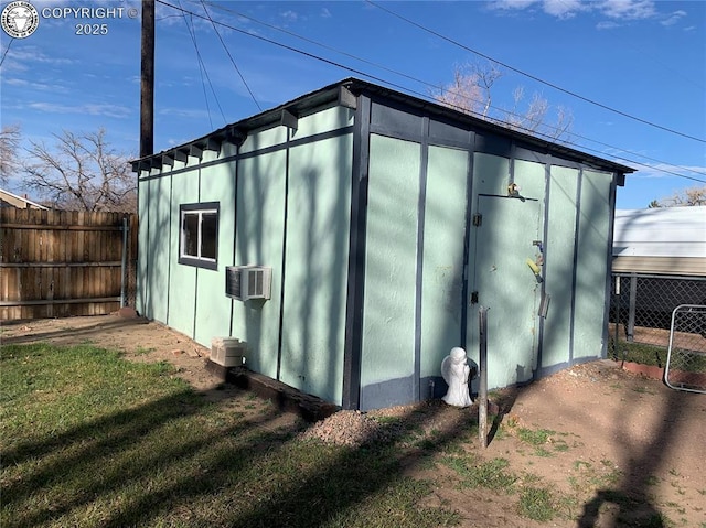 view of outbuilding featuring an outbuilding and fence