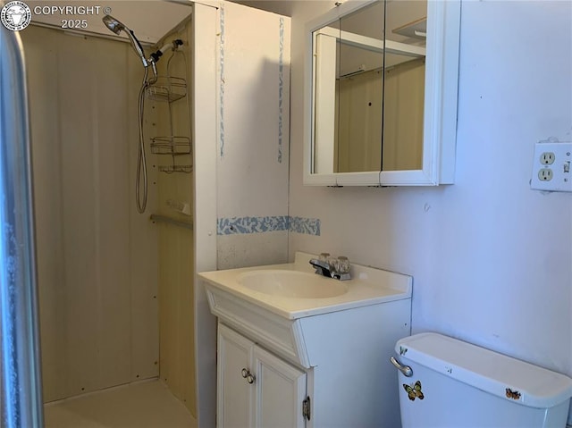 bathroom with vanity, toilet, and walk in shower