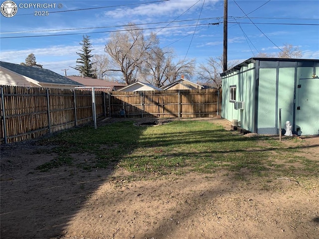 view of yard with a fenced backyard and an outdoor structure