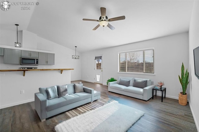 living room with ceiling fan, dark hardwood / wood-style floors, and vaulted ceiling