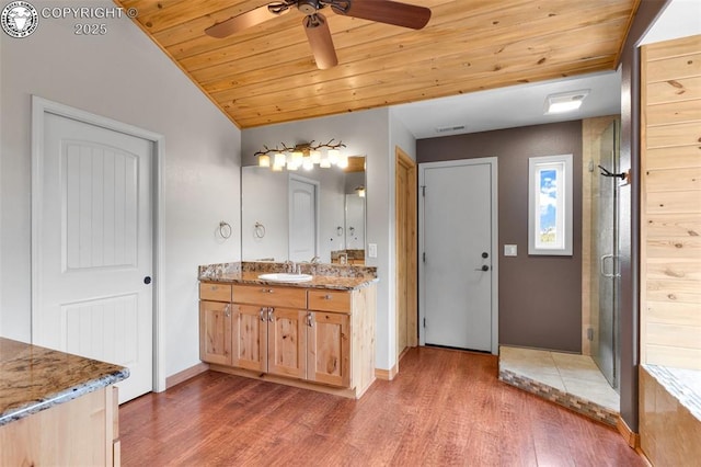 bathroom with walk in shower, wood ceiling, wood-type flooring, and vanity