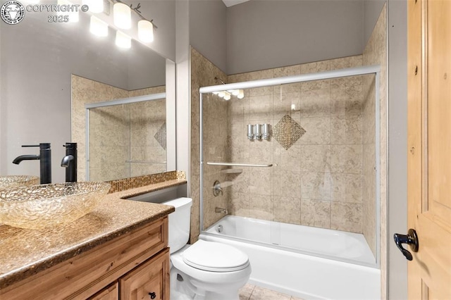 full bathroom with vanity, bath / shower combo with glass door, tile patterned floors, and toilet