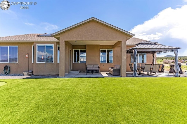 3528 Telegraph Trl, Canon City, CO 81212 - back of house featuring a gazebo, stucco siding, a patio area, and a lawn