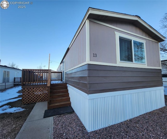 view of side of property featuring a deck