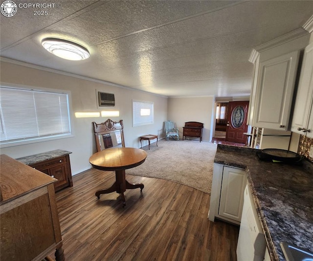 interior space featuring ornamental molding, a textured ceiling, and dark hardwood / wood-style flooring