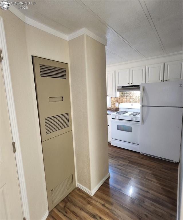 kitchen with crown molding, white appliances, dark hardwood / wood-style floors, and white cabinets