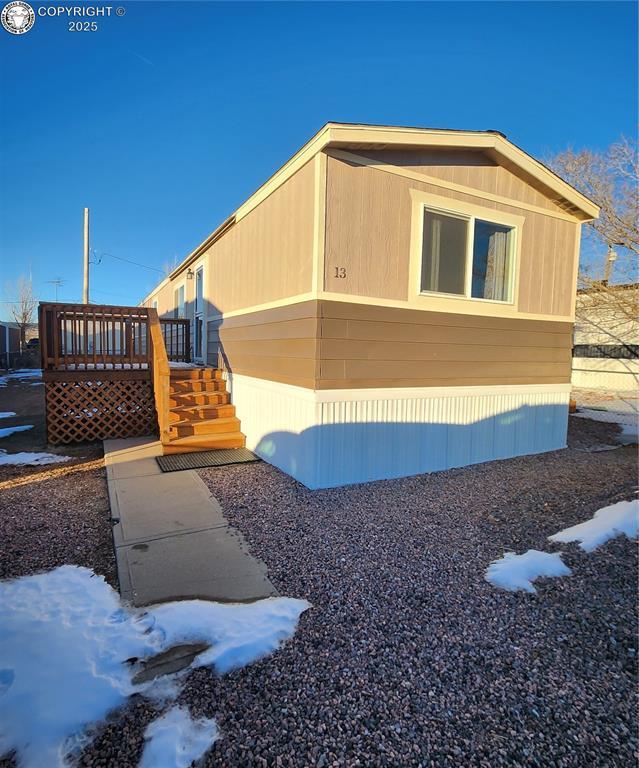 view of side of property featuring a wooden deck