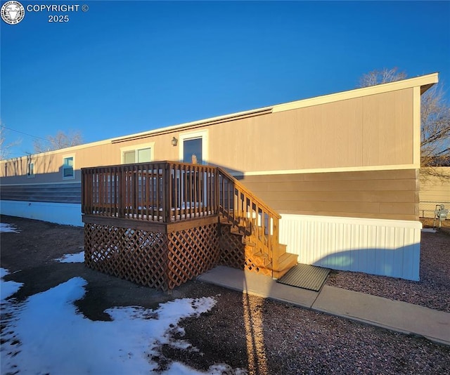 rear view of property featuring a wooden deck