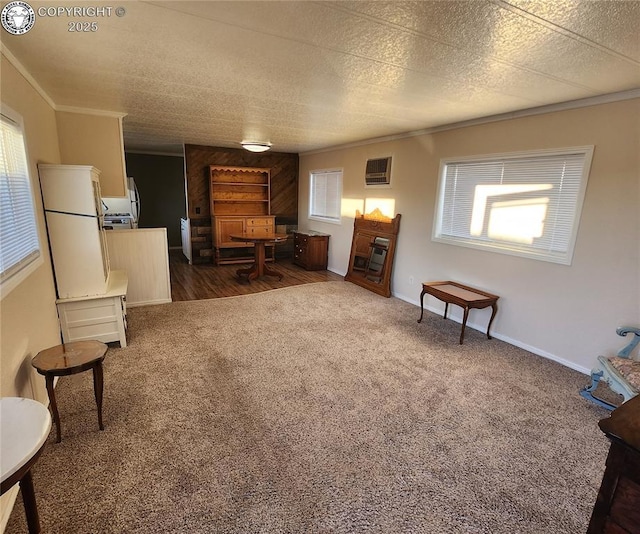 interior space featuring a wealth of natural light, ornamental molding, and dark colored carpet