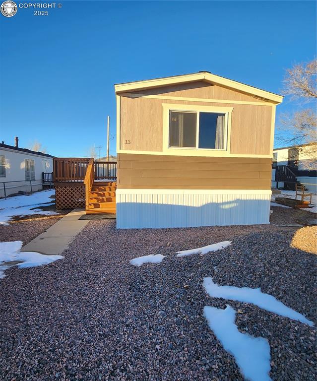 view of side of home with a deck