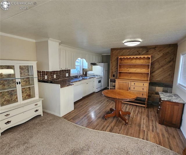 kitchen with white cabinetry, sink, white appliances, and crown molding