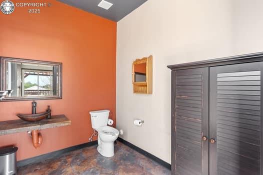 1704 Willow St, Brookside, CO 81212 - bathroom with toilet, baseboards, and a sink