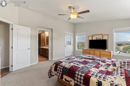 1704 Willow St, Brookside, CO 81212 - bedroom featuring baseboards, light carpet, connected bathroom, and a ceiling fan
