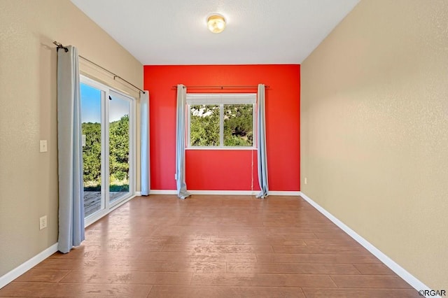 unfurnished room featuring hardwood / wood-style flooring