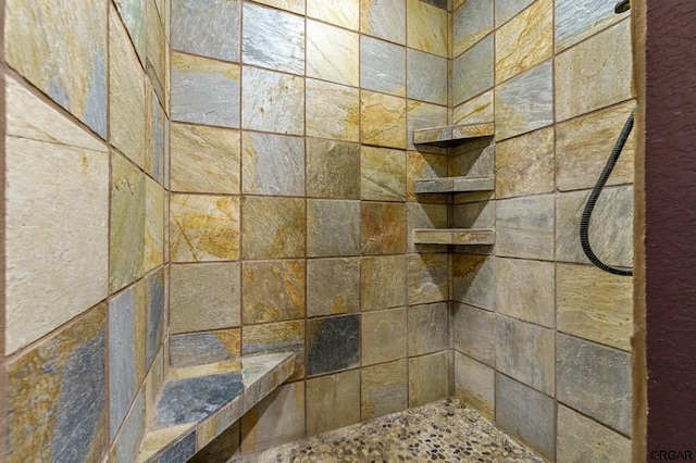 bathroom with tiled shower