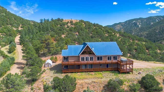 exterior space with a storage unit and a deck with mountain view