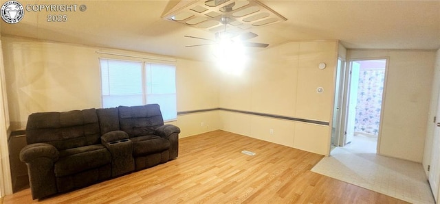 living room with hardwood / wood-style flooring, lofted ceiling, a healthy amount of sunlight, and ceiling fan