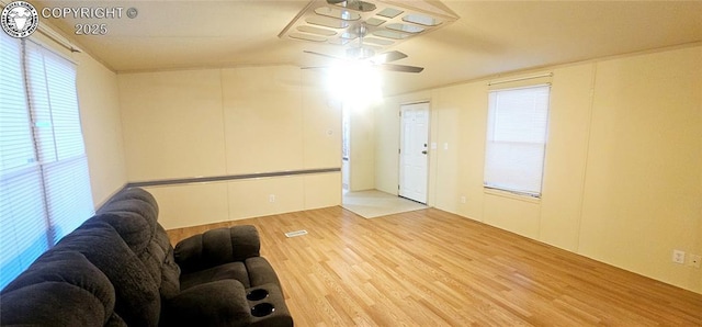 unfurnished living room featuring hardwood / wood-style floors and ceiling fan