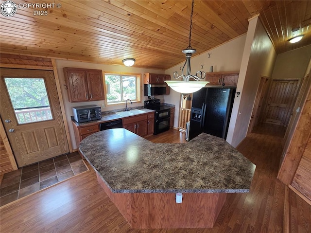 612 Lowry Ln, Canon City, CO 81212 - kitchen featuring black appliances, wooden ceiling, vaulted ceiling, brown cabinets, and hanging light fixtures